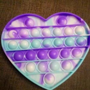 Selling 3 pop its green circle  pink circle and  multi color heart.